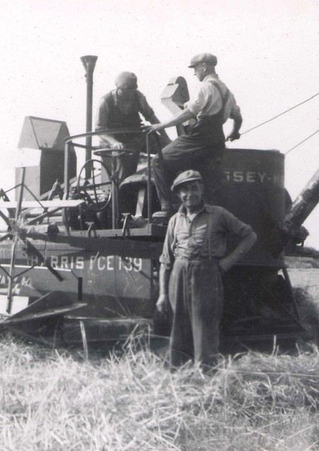 A photo of farmers on their equipment, from the early twentieth century. 